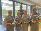 5 people holding volunteering award