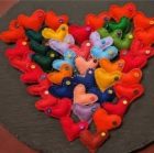 Photo showing small felt hearts laid out in the shape of a large heart