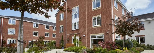 An image showing the front of Avery Place care home and part of the gardens